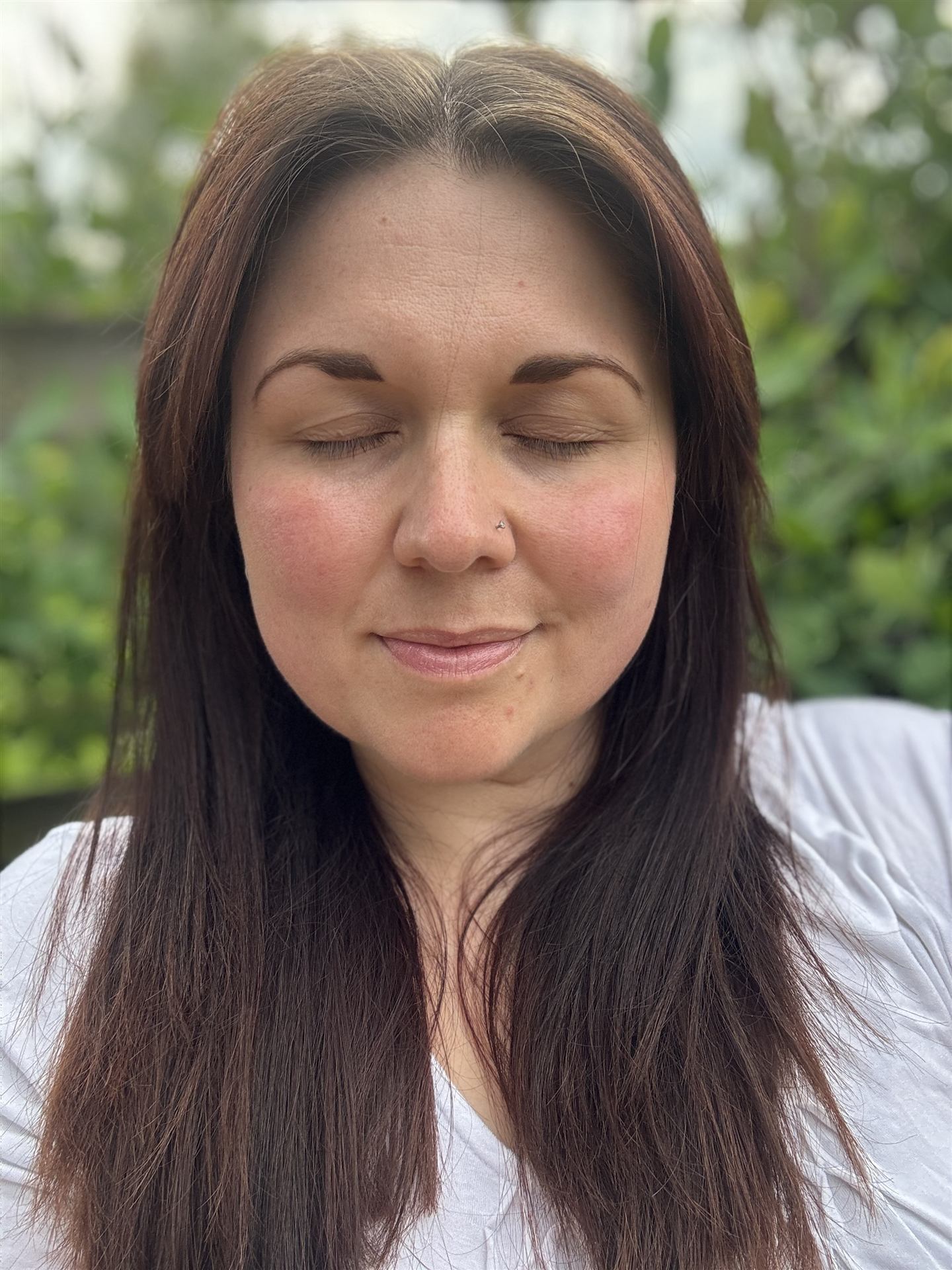 Hannah Monksummers, eyes closed, at peace outdoors
