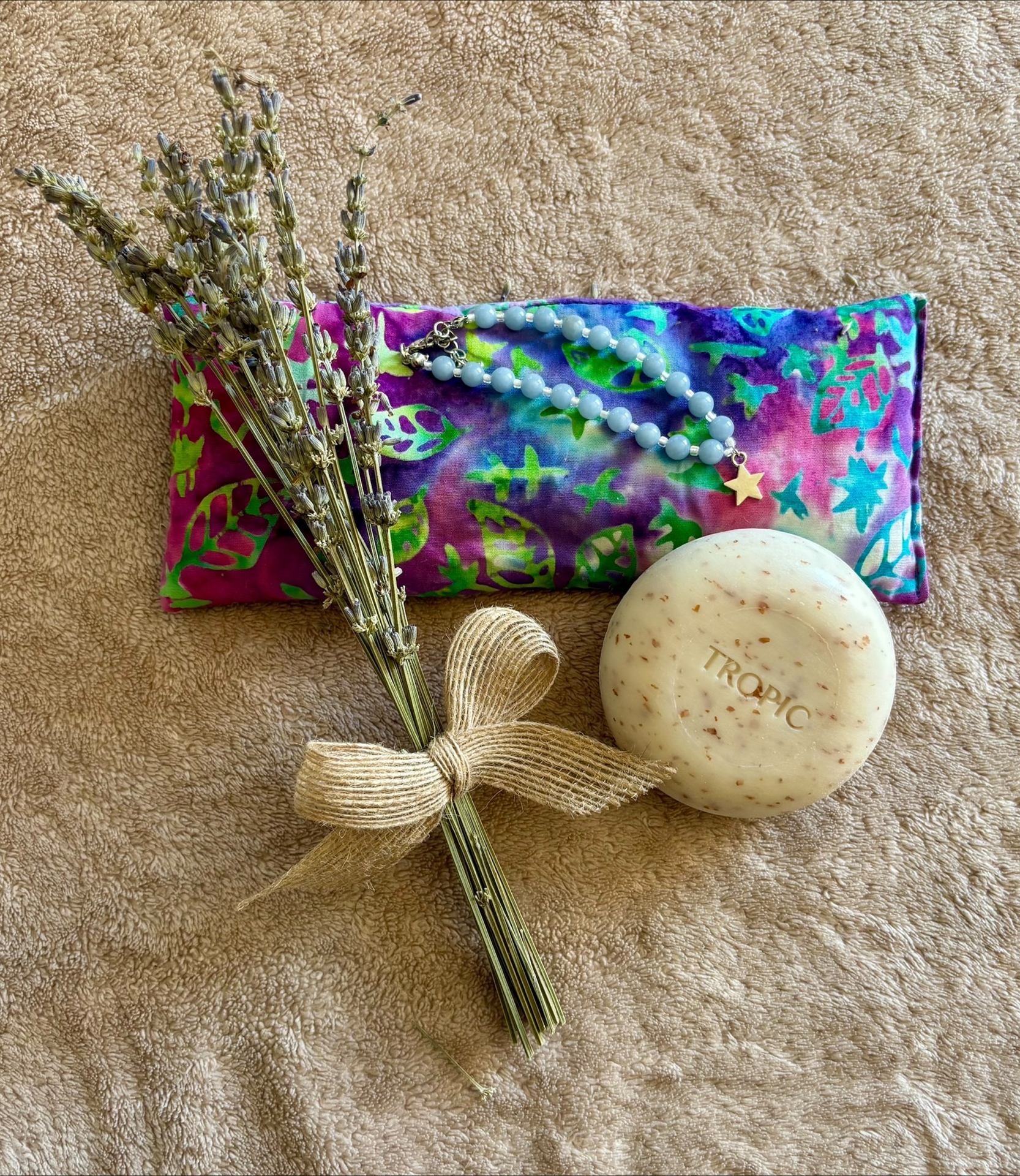 Lavender sprigs, a soothing eye pillow, a beaded bracelet and a bar of soap