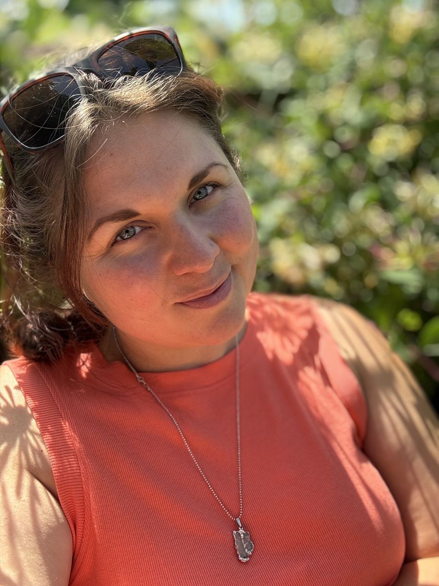 Hannah Monksummers smiling warmly, direct to camera, outdoors